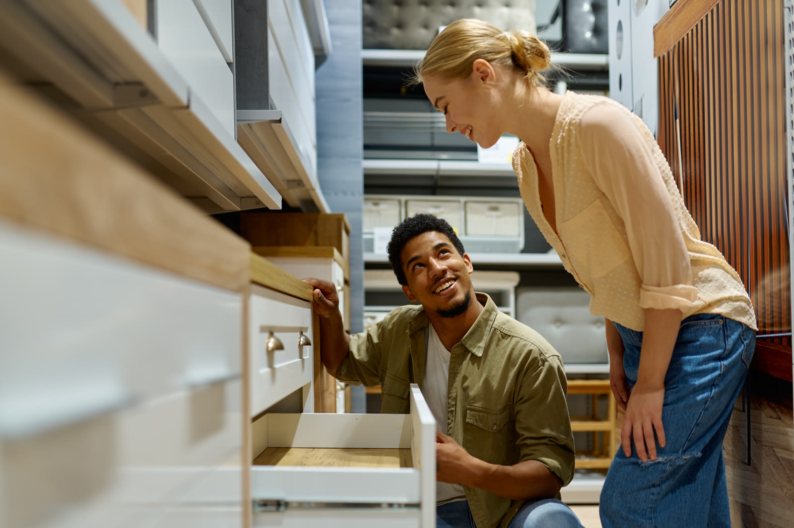 A couple opening a drawer to check a cabinet's construction